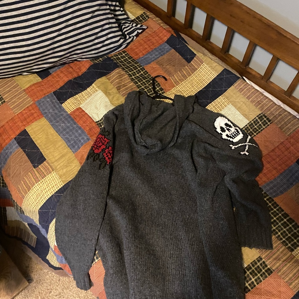 Full zip sweater with hood. Roses and skulls on sleeves.